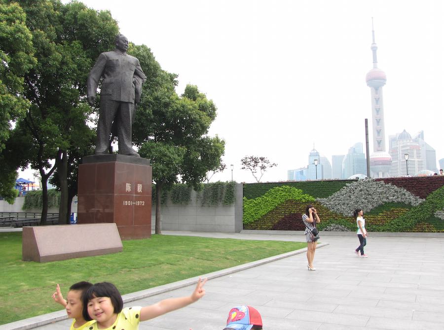 Mao statue in Shanghai, China with financial district in the background