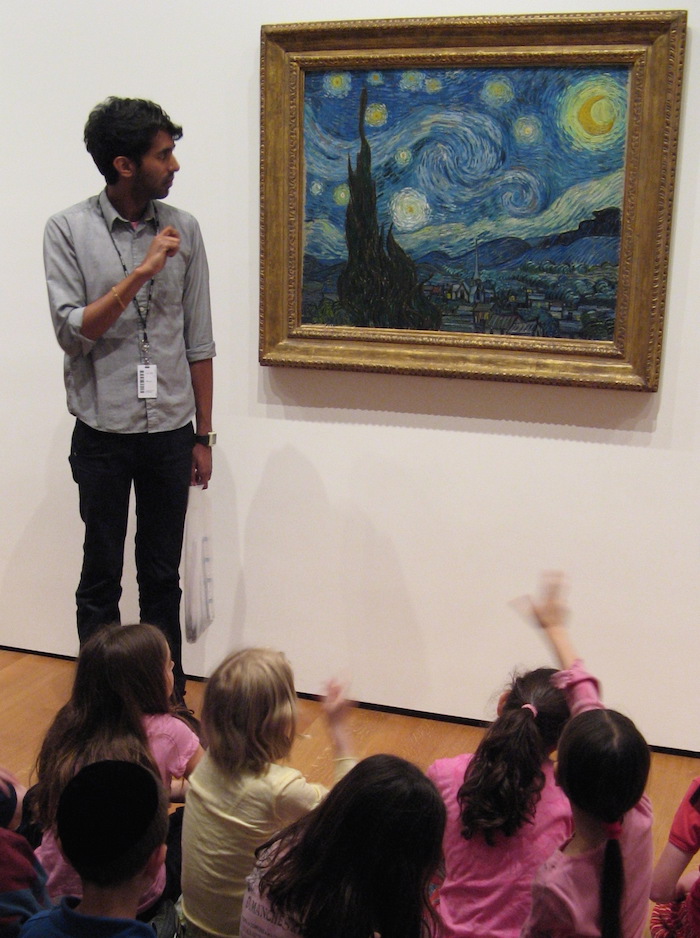 The Starry Night at the MET with a teacher standing and students sitting